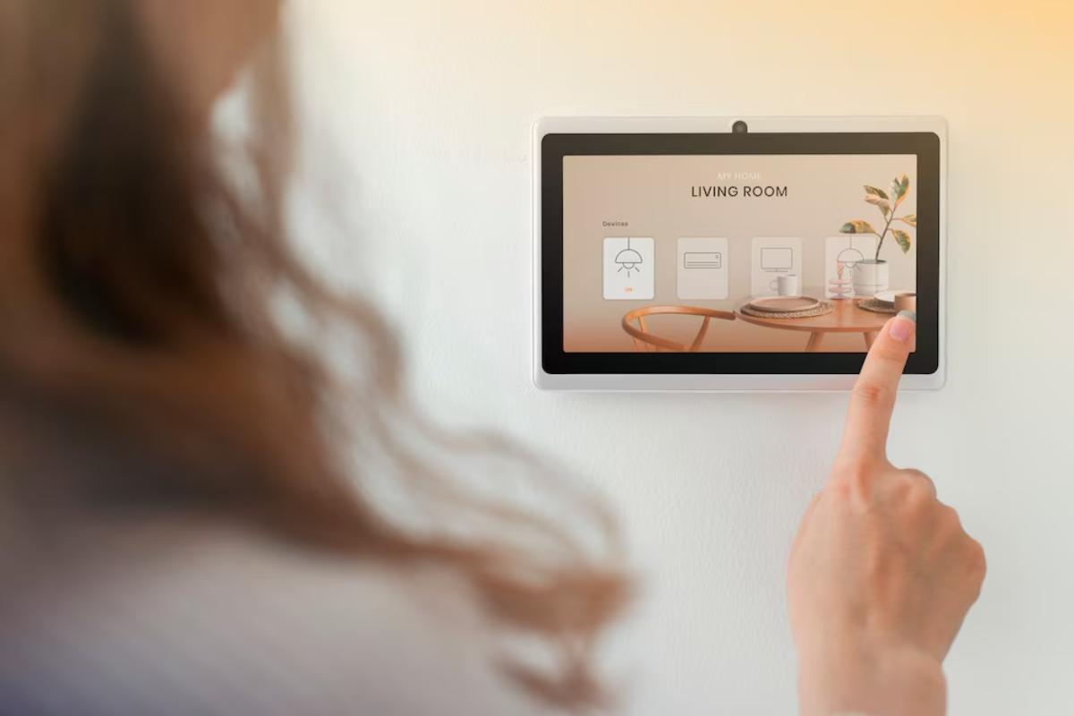 A person interacts with a smart home control panel displaying options for the living room, featuring lighting and appliance controls.