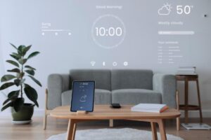 A modern living room featuring a tablet on a coffee table, displaying a virtual morning greeting and schedule projected on the wall.